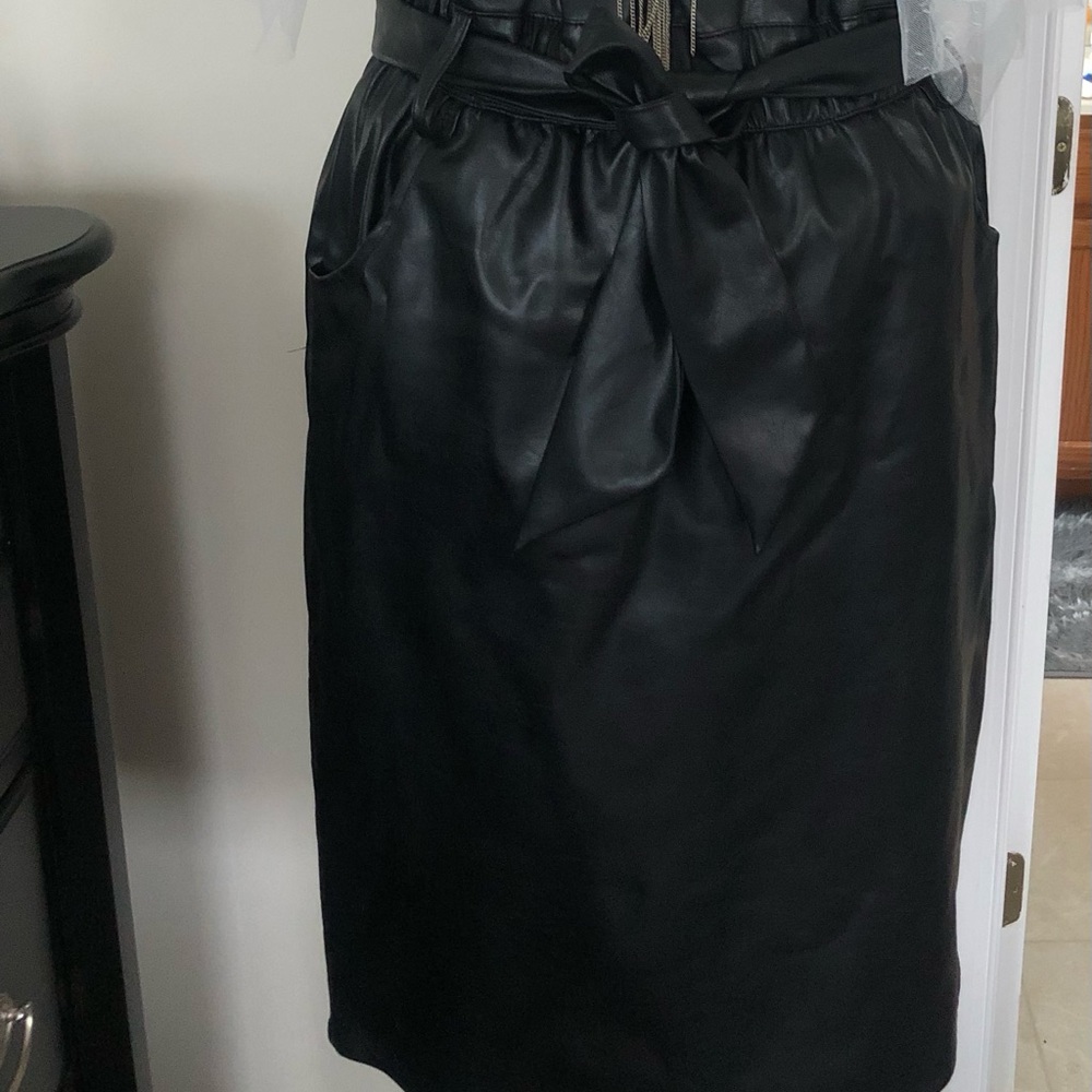 Faux leather black skirt with tie around the waist.